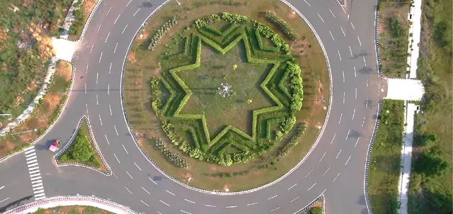 Aerial view of the landscaped central rotary at Reliance MET City Jhajjar